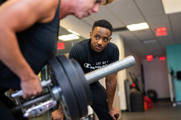 personal trainer helping a YMCA Pittsburgh member